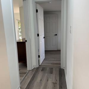 At the top of the stairs is the other full bathroom. Door to the left is the front bedroom and at the end of the hall is the back bedroom