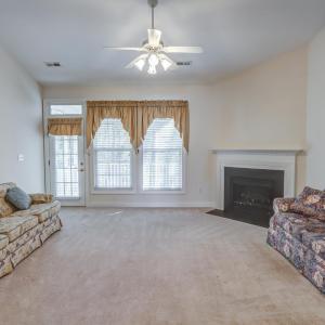 Large great room with electric fireplace opens up to screened porch
