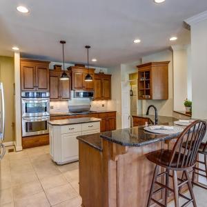 Chef's kitchen open to den and breakfast area