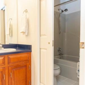 hall bath with 2 sinks and separate tub shower
