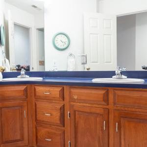 hall bath with 2 sinks and separate tub shower