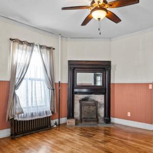 First room on Left from foyer. Finishing materials are left in places~ here the original tiles from around the firebox. Happily radiators were left in the house in case a new owner ever wants to revert back to steam heat!