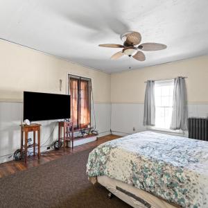 There is a nice large closet on the left. The curtained opening with a step here goes to the sunporch on the back of the house.