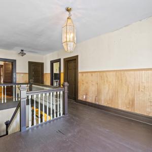 Upstairs the floors have been painted. The rooms follow around the corners of the house. The entrance to Bedroom 2 is to the right in this picture