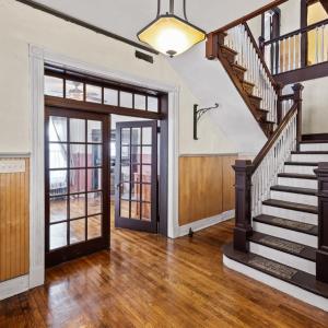 Center staircase, matching french door/lights flanking the foyer, restored ceilings and walls throughout.