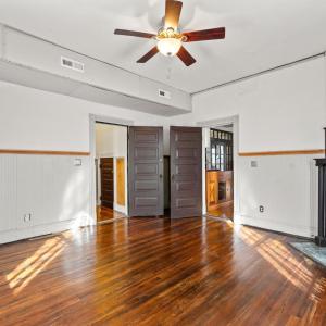 Door on right is the front room off the foyer. Door on left leads to a hallway with downstairs full bath.