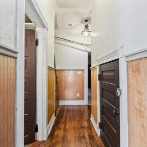 Door on left is the full bath. Door on right is storage closet with shelves under the stairs. Straight ahead is the hall to the back of the house.