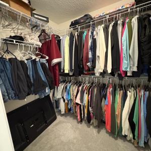 Walk in closet off primary bedroom .