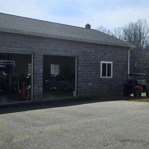 Huge 30' x 44' Garage includes car lift, wood stove & extra work space. This garage can house 4 cars if space to right is utilized, as it is now & still have space for work areas. In ground water line installed but not hook up to garage, but it could be.