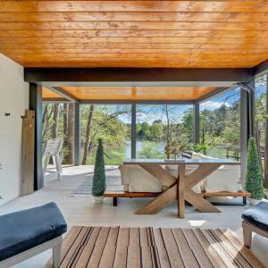 a seamless blend of elegance and openness, this property features expansive outdoor living areas to rival its sophisticated indoor spaces overlooking the breathtaking beauty of Smith Mountain Lake!