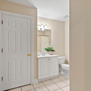 Full bathroom of Bedroom 1 ensuite with pantry space.