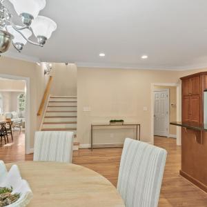 Breakfast area looking towards back staircase that leads to second level of home.  Formal dining to the right.