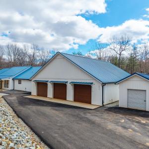 Exterior of Home with paved driveway and storage shed