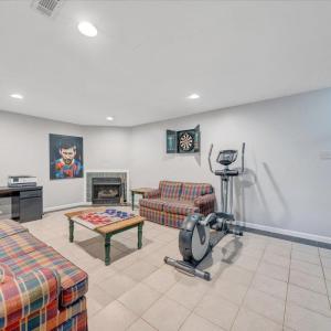 Spacious rec room in the basement level with gas log fireplace