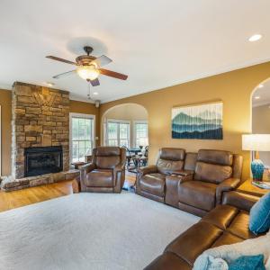 Family room with propane fireplace, tall ceilings, crown molding, surround sound, hardwood floor, arched entry ways and plenty of windows!