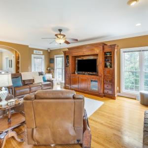 Family room with propane fireplace, tall ceilings, crown molding, surround sound, hardwood floor, arched entry ways and plenty of windows! The beautiful veranda/side porch entry is off of the family room.