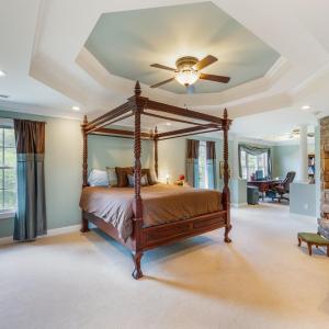 Primary bedroom suite with double tray ceilings, gas fireplace, office space and plenty of light!