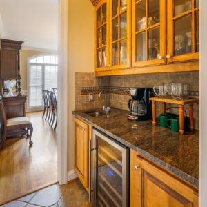 Butlers pantry that passes through from the kitchen to the dining room. Built in wine fridge, custom cabinets, and a bar sink!