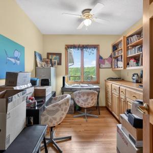 Office space with a mountain view out the window & built in shelves