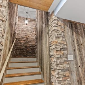 Custom stonework to give a French Cellar feel leading down to the terrace level.