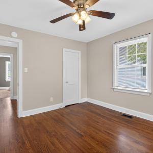 Spacious bedroom with designer updated paint and ceiling fan.