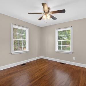 Spacious bedroom with designer updated paint and ceiling fan.