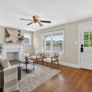 Bright living room with beautiful hardwood floors and a wood-burning fireplace.