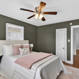 Spacious bedroom with designer updated paint and ceiling fan.