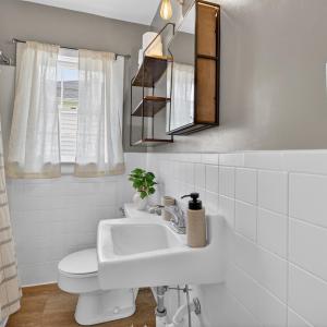 Charming bathroom with tile backsplash and fresh paint.