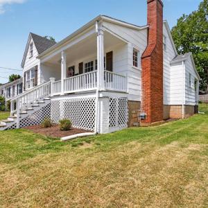 Fresh and bright bungalow with charming covered front porch.