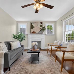 Bright living room with beautiful hardwood floors and a wood-burning fireplace.