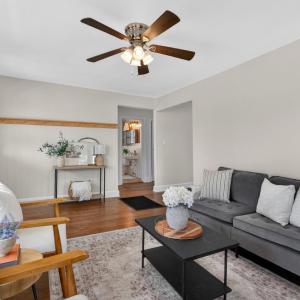 Bright living room with beautiful hardwood floors and a wood-burning fireplace.