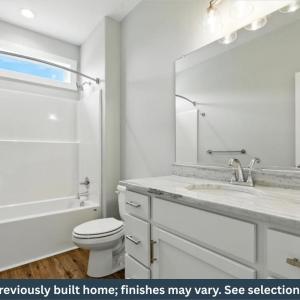 Hall Bath with fiberglass shower/tub combination and transom window, vanity and LVP flooring