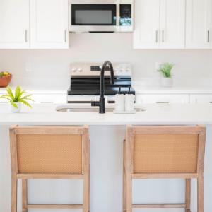 Open Concept kitchen with quartz counters, oversized island, door to deck, etc *Fridge ordered and scheduled to be installed.