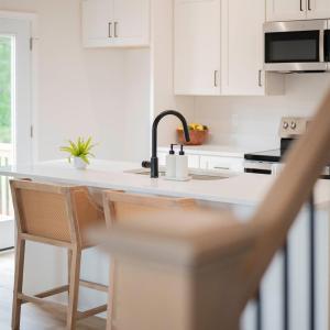 Open Concept kitchen with quartz counters, oversized island, door to deck, etc *Fridge ordered and scheduled to be installed.