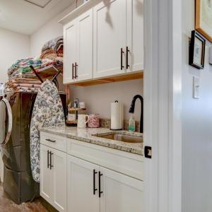 Great working Laundry room, with upper and lower cabinets (an upgrade) , with sink