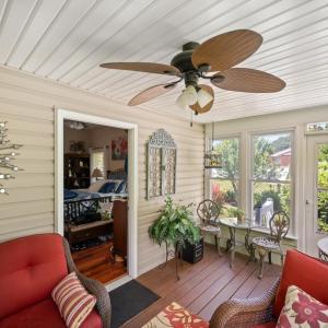 Walk out of the primary bedroom into this charming garden room filled with natural light and views of a beautifully landscaped backyard.