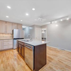 The kitchen has solid surface countertops and room for a table.