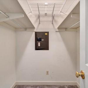 Primary bedroom closet with built-in safe