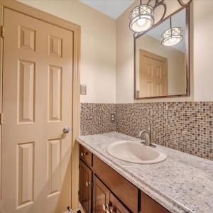 Jack and Jill half bath on the main level can be accessed from the rec room or from the hallway