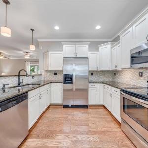 Gorgeous kitchen with granite counter tops and custom backsplash!  All appliances convey!