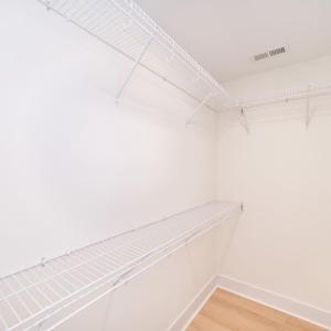 Walk in closet in primary bedroom.