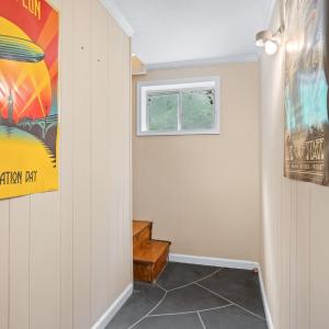 at the bottom of the newly constructed stairs and entering the lower level. Stamped concrete floors