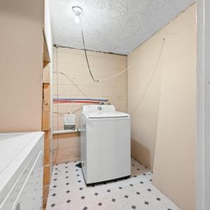 The laundry room is in the lower level just off the newly reconstructed stairs