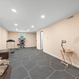 TV mount conveys. Door on right is the full bath. Back wall has exterior door on the right. Window is legal egress for bedroom.