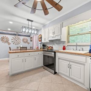 The kitchen is just off the Sunporch entrance with the eat-in area just past this island cabinet.