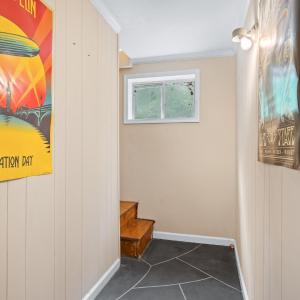 at the bottom of the newly constructed stairs and entering the lower level. Stamped concrete floors