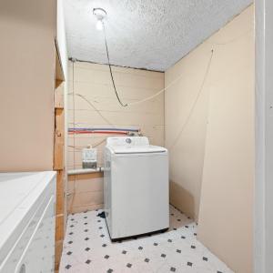 The laundry room is in the lower level just off the newly reconstructed stairs