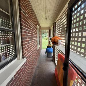 Enclosed area when exiting Kitchen door to back yard with helpful storage.