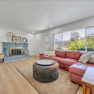Cozy up to your wood burning fireplace in this update living room space with tons of natural lighting!